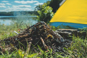 Bonfire next to the tent by the lake.