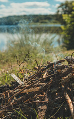 Bonfire next to the tent by the lake.