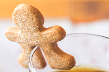Closeup of a cookie on the rim of a tea cup