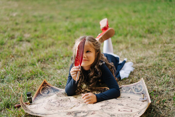 Cute Schoolgirl Hold Quill Pen World Paper Map. Pretty Caucasian Female Child Lie on Meadow Ground...