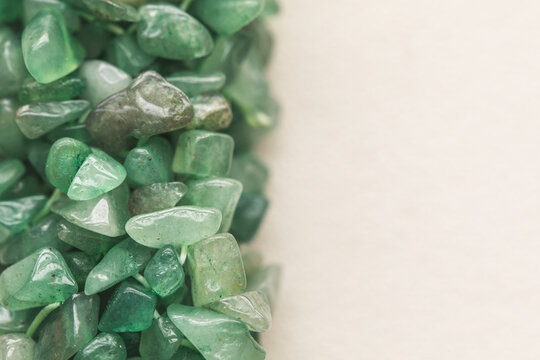 Polished pieces of green aventurine quartz on a white surface