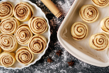 Prepare Cookie Confectionery Recipe Top View Photo. Uncooked Vegetarian Cakes Filled Cinnamon and Sugar. Rolled Dough with Spicy Ingredients Buns and Wooden Rolling Pin Utensil on Cuisine Desk