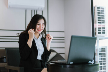  beautiful asian woman success business project with digital laptop computer happy and relax at workspace