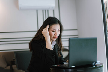 Beautiful young asian  business woman with headache at office