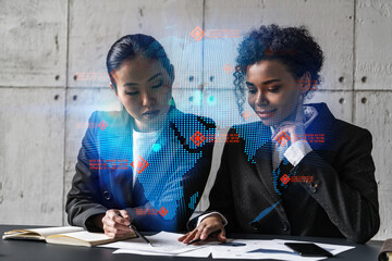 Two businesswomen work together in modern office on new project. Double exposure. Concept of success. Planet earth world map.