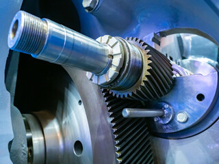 Metal part. Gears in a car engine. Concept - creation of parts for production machines. Mechanical gearbox. Concept - car parts close-up. Car engine manufacturing. Motor close-up.