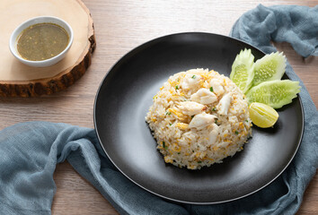 Delicious Fried rice with crab meat, egg, garlic, cucumber, lemon. Thai food called Khao pad poo.