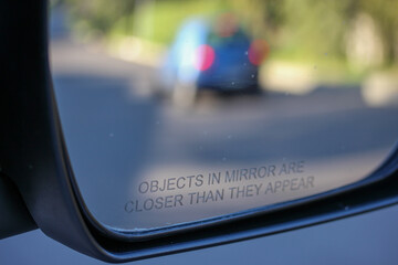 Rear-view mirror with reflection of a small car