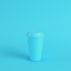 Coffee cup on bright blue background in pastel colors. Minimalism concept