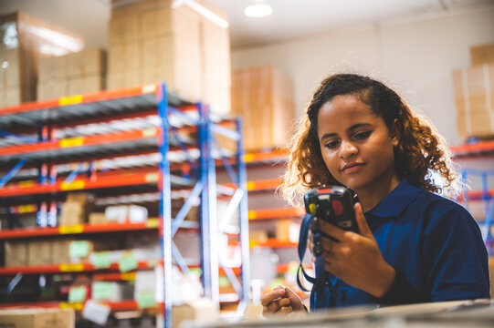 warehouse worker using bar code scanner to scanning box and analyze newly arrived goods for further placement in storage department, Working at warehouse.