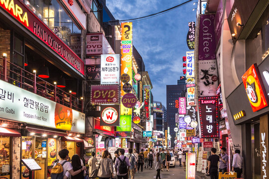 SEOUL, SOUTH KOREA - SEPTEMBER 12 2015: People wander in the walking street of the Myeong-dong shopping and entertainment district at night.