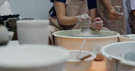 Obraz na płótnie Canvas Hand work on pottery wheel, shaping a clay pot