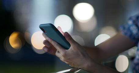 Use of mobile phone in city at night