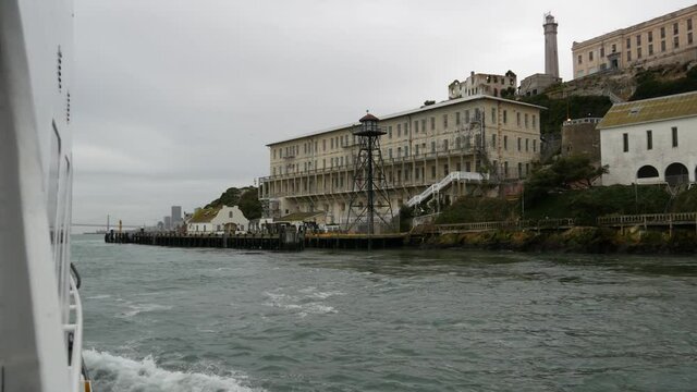 Alcatraz island in San Francisco Bay, California USA. Federal prison for gangsters on rock, foggy weather. Historic jail, cliff in misty cloudy harbor. Gaol for punishment and imprisonment for crime.