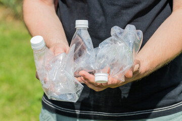 Man holding crushed plastic bottles in his hands, Eco friendly lifestyle, Zero Waste