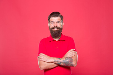 Hairdresser salon. Brutality and confidence. Barbershop model. Perfect male. Portrait of bearded man red background. Brutal caucasian guy with mustache. Hipster with beard. Unshaven man with beard