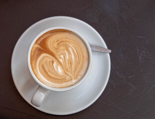 Italian cappuccino coffee cup on wooden table surface