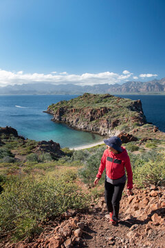 One woman hiking on a trail in Del Carmen Island at Loreto Bay