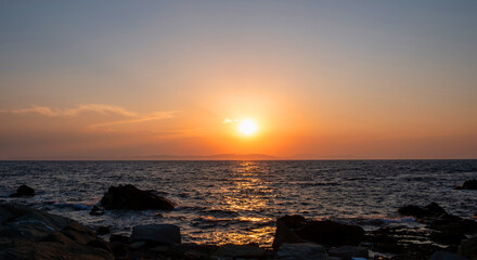 Sunrise, sunset.Twilight, dusk sky over sea water, land silhouette