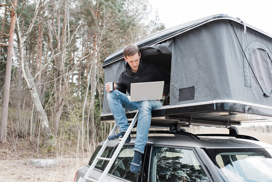 man working from a home office in a tent whilst social distancing