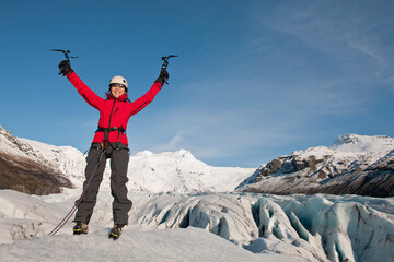 woman feeling victorious on the Fjallsj√∂kull glacier in Iceland