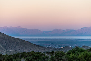 Fototapeta na wymiar La Luz, New Mexico town view of Organ Mountains and White Sands Dunes National Monument at twilight sunset high angle above perspective with horizon