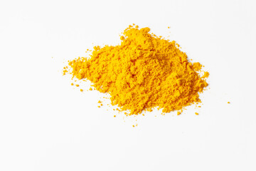 A pile of turmeric spice powder on a white background.