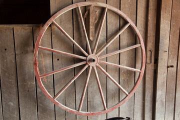 Wagon Wheel against a wooden wall