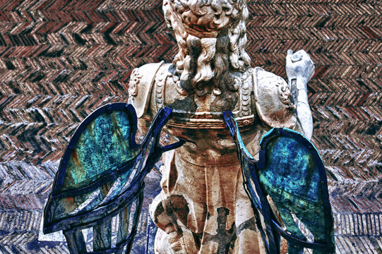 Top-behind view of an angel statue with copper wings