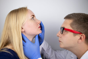 The otolaryngologist examines the girl's nasal passages. Painful sensations in the nose, polyps, adenoids and shortness of breath. Fractures of the cartilage tissue of the nose