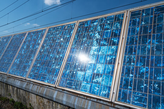 Mosaic Solar panels with sun rays and cloud reflections