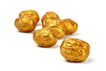 Golden walnuts on a white background