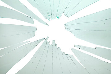 Broken and cracked glass with hole on a white background