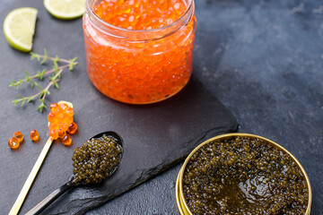 Fresh red and black caviar, seafood, dark background, top view. Good food. Delicious food content
