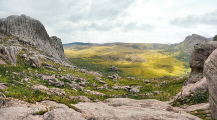 View from Andringitra massif as seen during trek to Pic Boby Imarivolanitra, Madagascar highest accessible peak. Small person in bottom left corner for scale