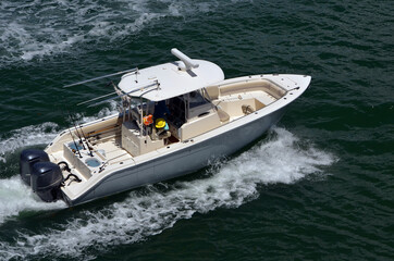 Angled overhead view of a high-end one sport fishing boat with a canopied center console.