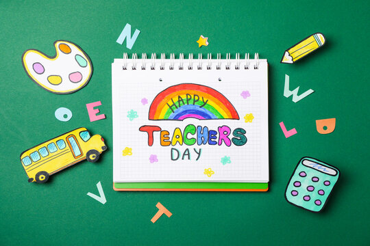 Notebook with Happy teachers day and decorative school supplies on green background