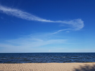 The faint clouds above the sea at a beach.