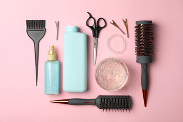 Flat lay with hairdresser accessories on pink background, top view
