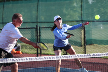 Pickleball net action during a mixed doubles match