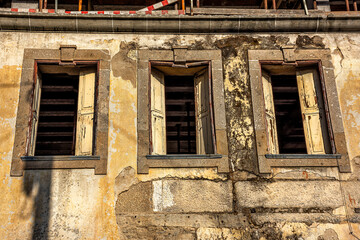 Derelict Building With Three Open Windows And Shutters, Braga, Portugal