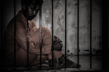 Asian man desperate at the iron prison,prisoner concept,thailand people,Hope to be free,Serious...
