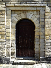 Fototapeta na wymiar Main door of the Mozarab Pre-Romanesque or Romanesque Church of San Pedro de Larrede in the Serrablo Region. 10th-11th century. Aragon. Spain. 
