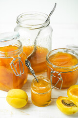 Fresh delicious apricot jam on a white background