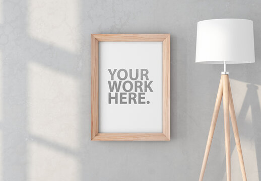 Vertical Wooden Frame Mockup Hanging on Wall with Floor Lamp