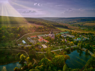 Flight over a christian monastery surrounded by autumn forest. Kurky monastery, Moldova republic of. © Igor Syrbu