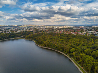 Fototapeta na wymiar Aerial view of a lake in a park with autumn trees. Kishinev, Moldova. Epic aerial flight over water. Colorful autumn trees in the daytime.