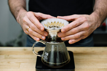 Barista preparing coffee with filter