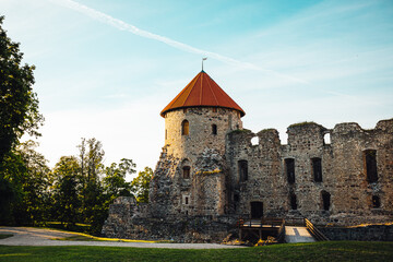 Fototapeta na wymiar View on beautiful ruins of ancient Livonian castle in old town of Cesis, Latvia, warm sunset time.