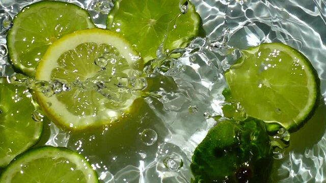 Falling of segments of a lemon and lime. Slow motion.
